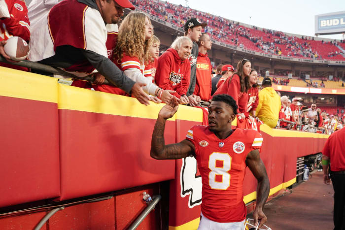 Justyn Ross high fives fans in the stadium